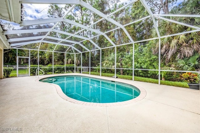 view of pool featuring a patio and glass enclosure