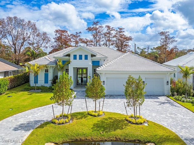 view of front of house featuring a front yard and a garage