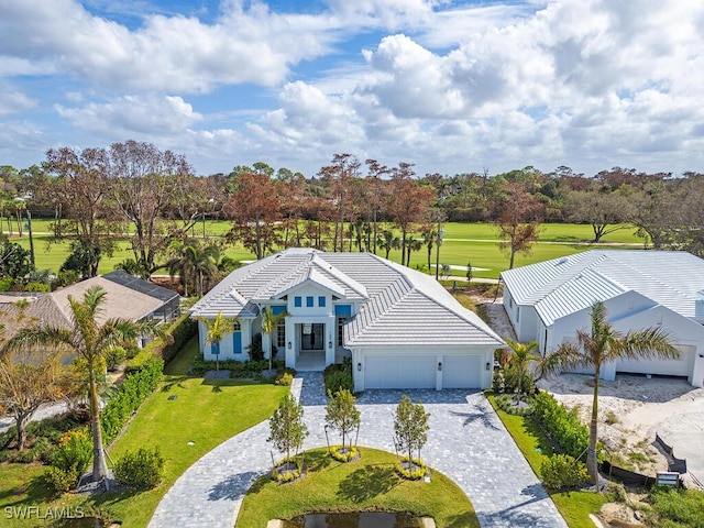 view of front of home with a front yard and a garage