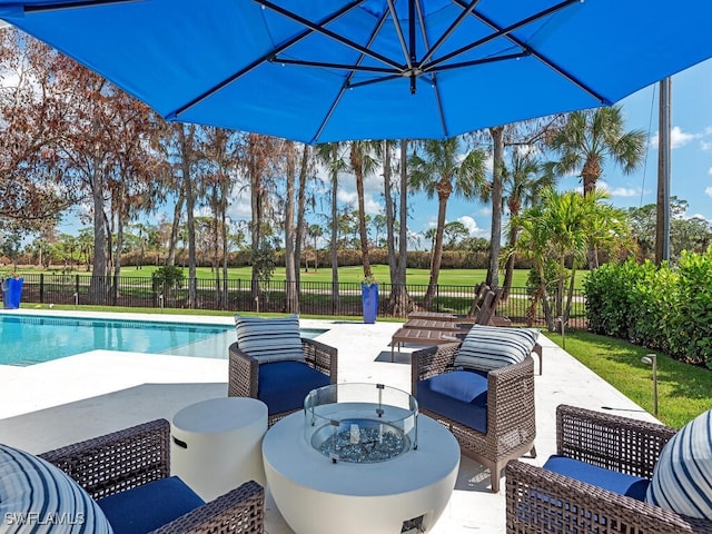 view of swimming pool featuring an outdoor living space, a patio area, and a lawn