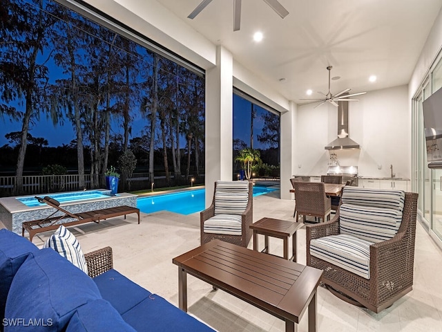 patio at twilight with exterior kitchen, sink, outdoor lounge area, a fenced in pool, and ceiling fan