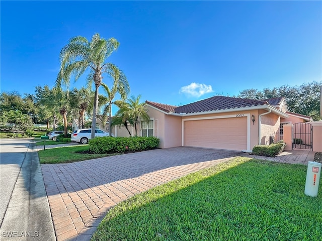 view of front of home with a front yard and a garage