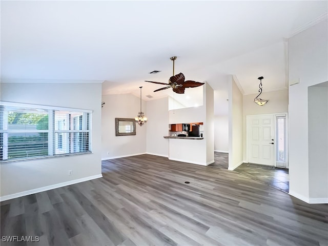 unfurnished living room featuring ceiling fan with notable chandelier, ornamental molding, dark hardwood / wood-style flooring, and lofted ceiling