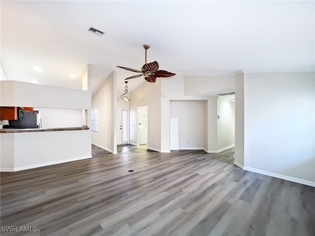 unfurnished living room featuring ornamental molding, ceiling fan, hardwood / wood-style floors, and lofted ceiling