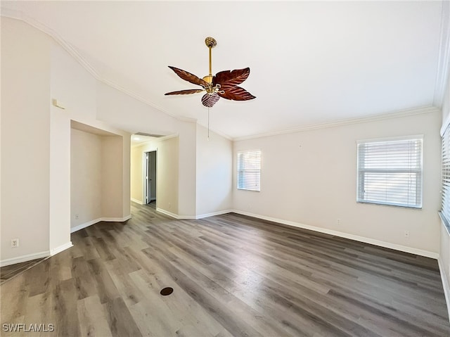 unfurnished room featuring wood-type flooring, plenty of natural light, ceiling fan, and ornamental molding