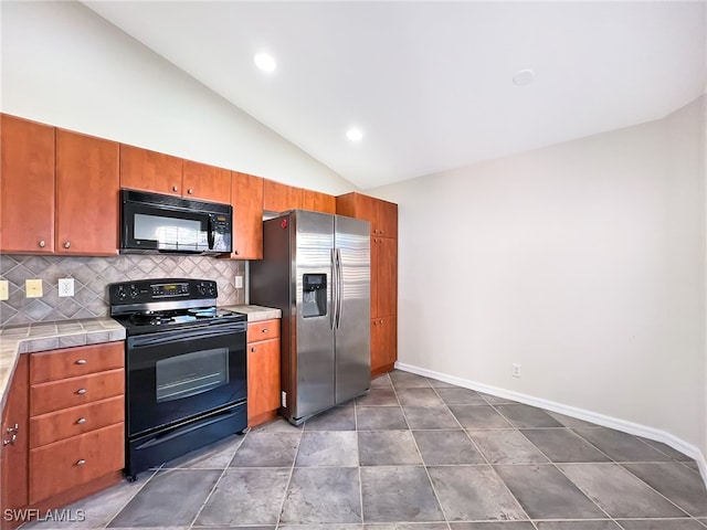 kitchen featuring black appliances, backsplash, high vaulted ceiling, and tile counters