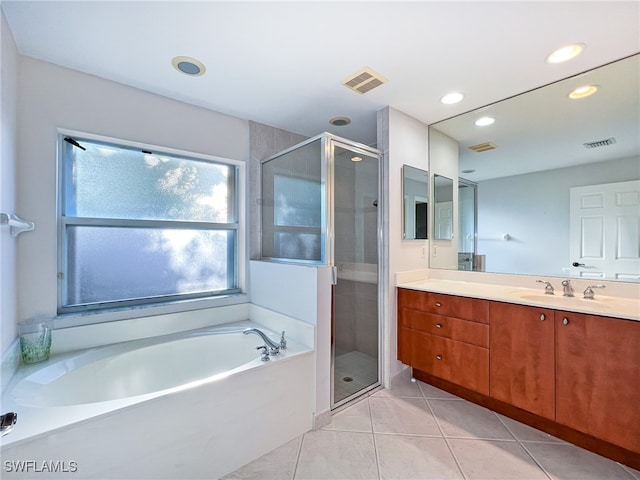 bathroom featuring independent shower and bath, vanity, and tile patterned flooring