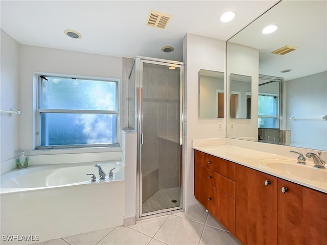 bathroom featuring independent shower and bath, tile patterned floors, and vanity