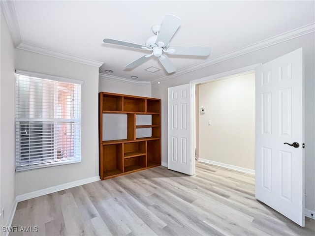 unfurnished bedroom featuring ceiling fan, ornamental molding, and light wood-type flooring