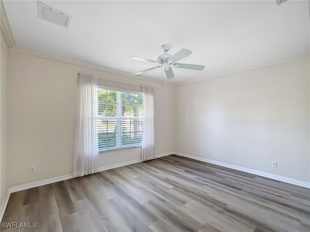 unfurnished room with light hardwood / wood-style floors, ceiling fan, and ornamental molding