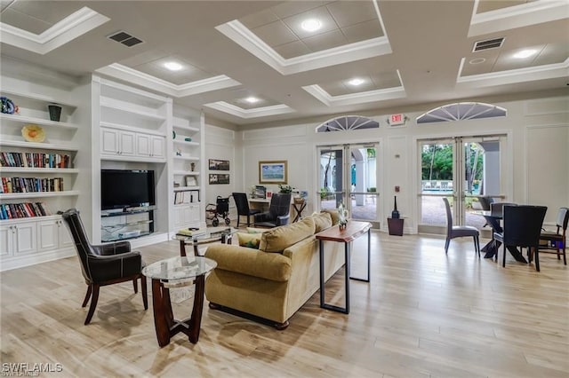 living room with built in shelves, french doors, light wood-type flooring, crown molding, and coffered ceiling