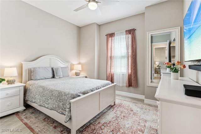 tiled bedroom featuring ceiling fan