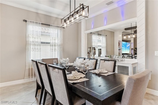 dining room with a wealth of natural light, crown molding, and light tile patterned floors