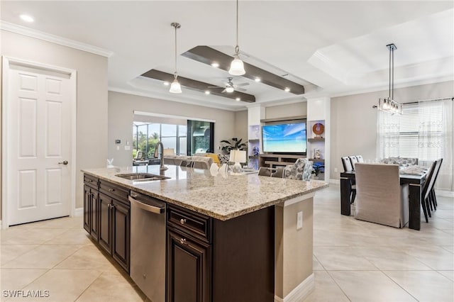 kitchen featuring stainless steel dishwasher, a tray ceiling, ceiling fan, hanging light fixtures, and an island with sink