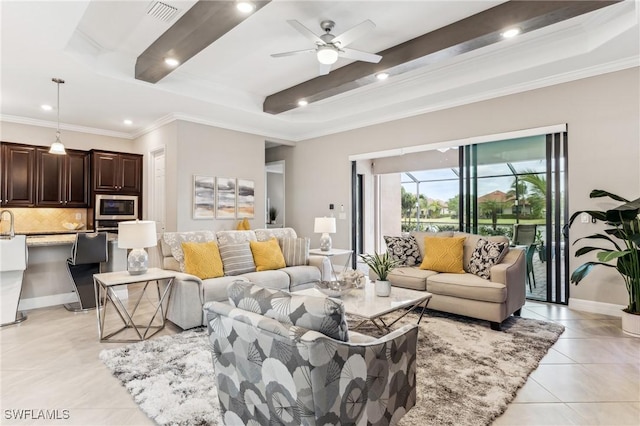 tiled living room featuring ceiling fan, sink, and ornamental molding