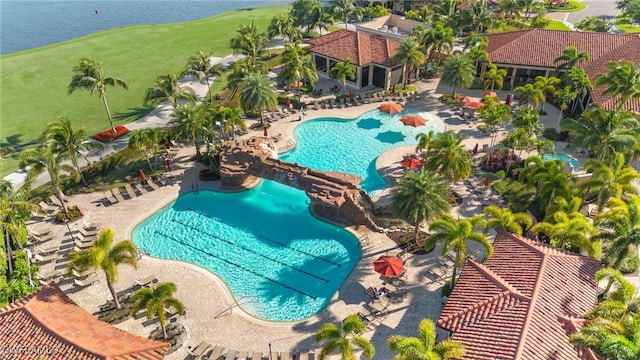 view of swimming pool featuring a patio area and a water view