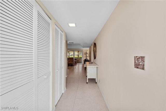 hall with light tile patterned flooring