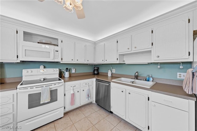 kitchen featuring sink, white appliances, light tile patterned floors, and white cabinets