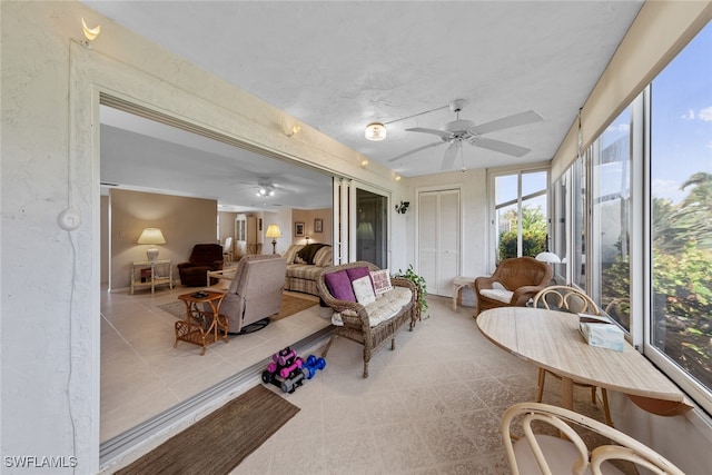 sunroom / solarium featuring ceiling fan