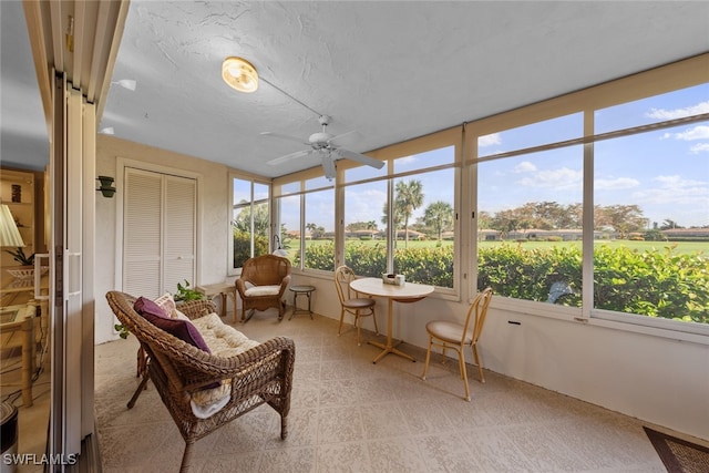 sunroom / solarium with a rural view and ceiling fan