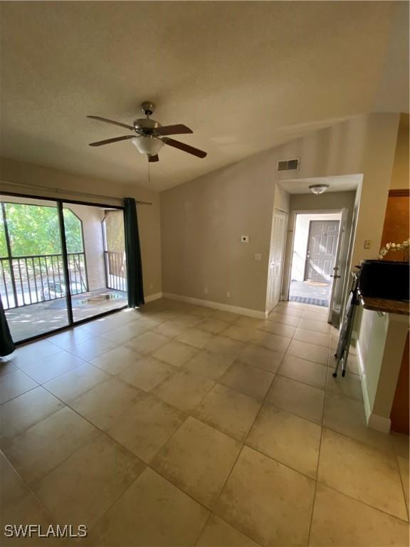 unfurnished room with light tile patterned floors and ceiling fan