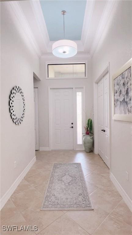3195 Pacific Dr, Naples, FL 34119 - entryway featuring crown molding, light tile patterned floors, a towering ceiling, a raised ceiling, and baseboards
