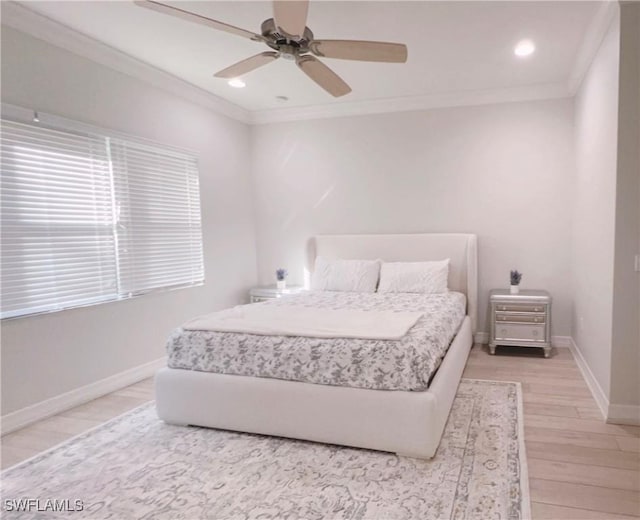 bedroom with crown molding, hardwood / wood-style floors, and ceiling fan