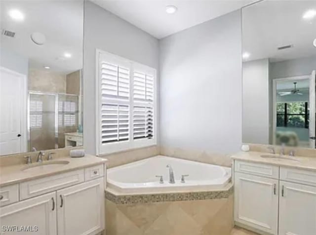 3195 Pacific Dr, Naples, FL 34119 - full bathroom with a shower stall, a bath, visible vents, and a sink