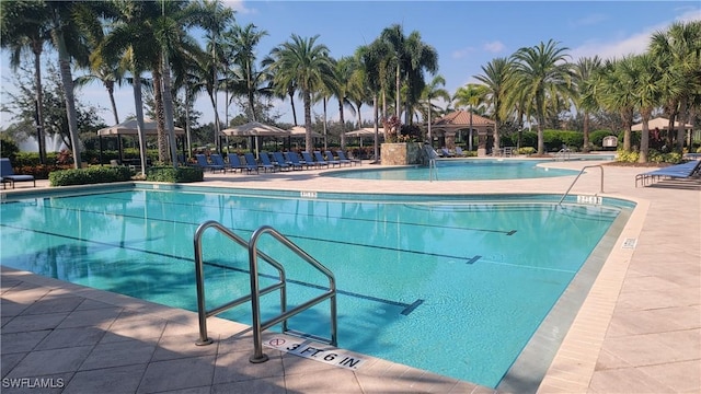 3195 Pacific Dr, Naples, FL 34119 - community pool featuring a patio
