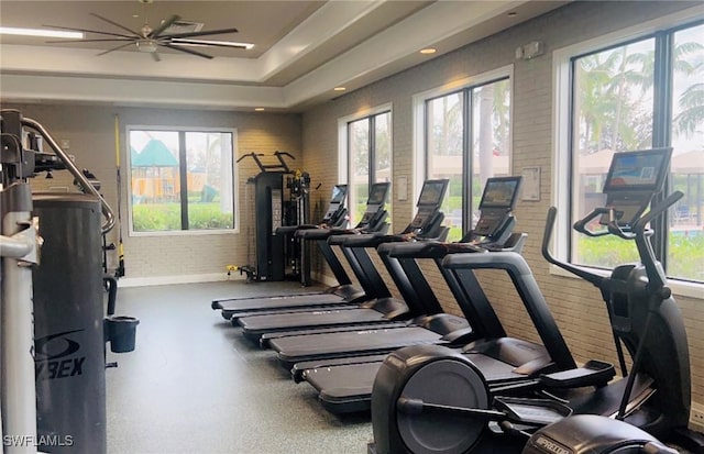 3195 Pacific Dr, Naples, FL 34119 - workout area with brick wall and a ceiling fan