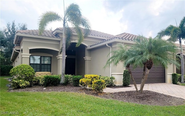 3195 Pacific Dr, Naples, FL 34119 - view of front of house featuring concrete driveway, stucco siding, an attached garage, and a tile roof