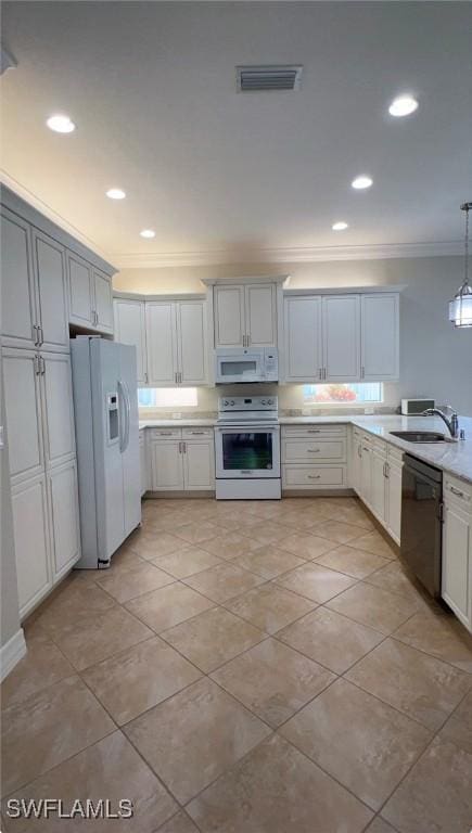 3195 Pacific Dr, Naples, FL 34119 - kitchen with white appliances, ornamental molding, visible vents, light countertops, and a sink