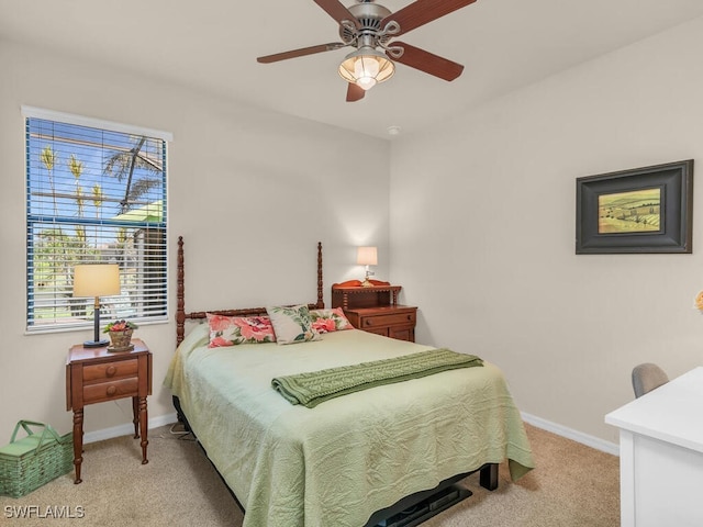 bedroom featuring ceiling fan, baseboards, and light colored carpet