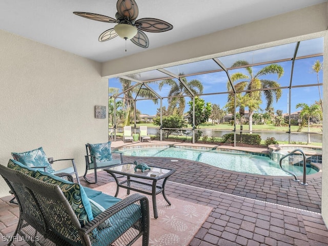 exterior space with ceiling fan, a water view, and a pool