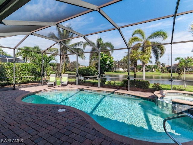 view of pool with a water view, glass enclosure, a pool with connected hot tub, and a patio