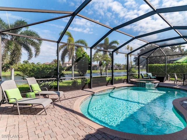 view of swimming pool with a pool with connected hot tub, glass enclosure, and a patio