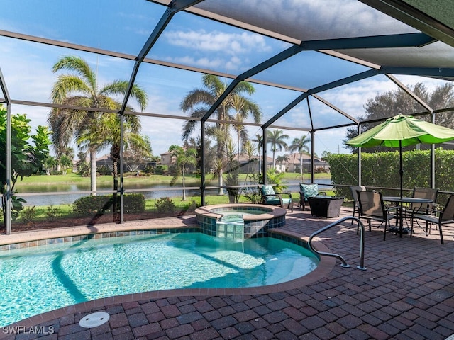 view of pool with a pool with connected hot tub, a water view, a patio, and a lanai