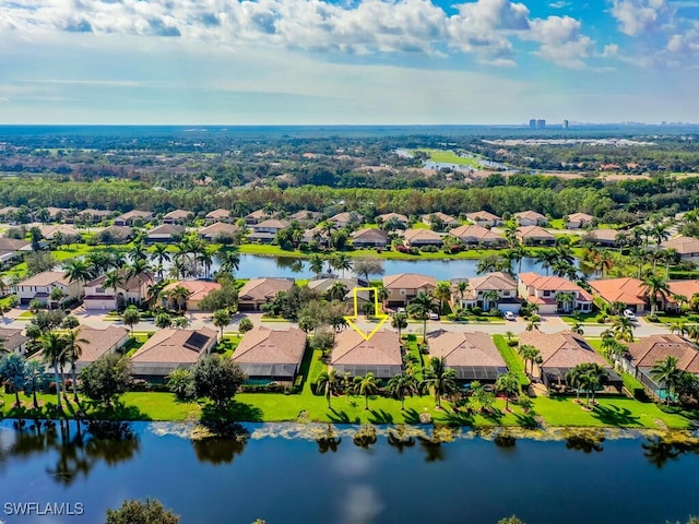 birds eye view of property with a water view and a residential view