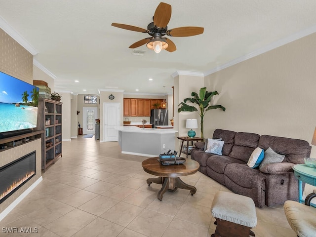 living room featuring a fireplace, visible vents, crown molding, and light tile patterned flooring