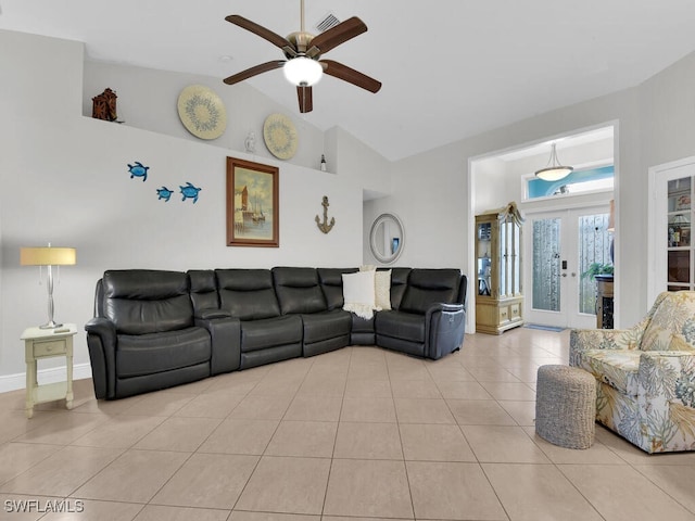 tiled living room with french doors, ceiling fan, and high vaulted ceiling