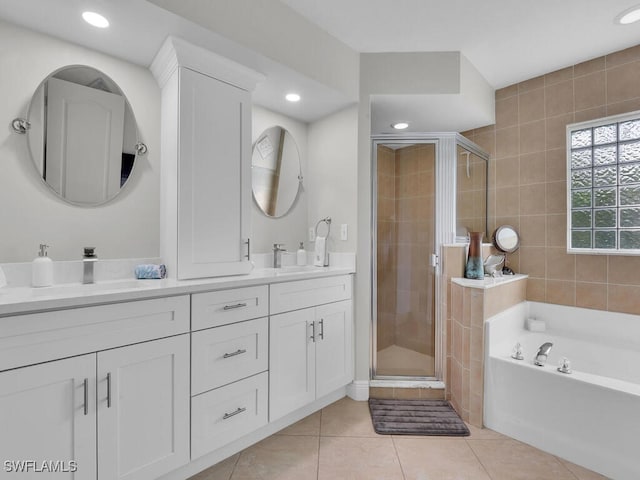 bathroom featuring tile patterned flooring, shower with separate bathtub, and vanity