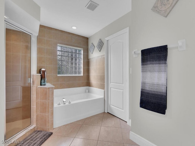 bathroom featuring independent shower and bath, tile patterned floors, and tile walls