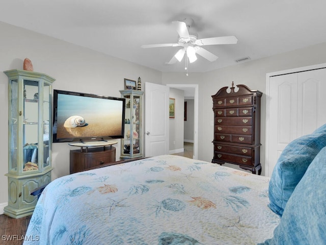 bedroom with a closet, hardwood / wood-style floors, and ceiling fan