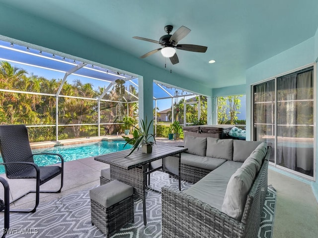 view of patio with ceiling fan, glass enclosure, a pool with hot tub, and an outdoor hangout area