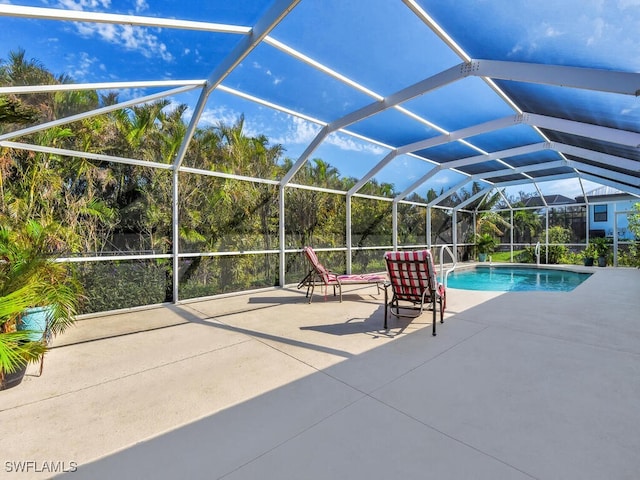 view of pool with a lanai and a patio