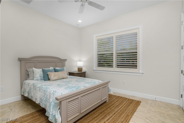 tiled bedroom featuring ceiling fan