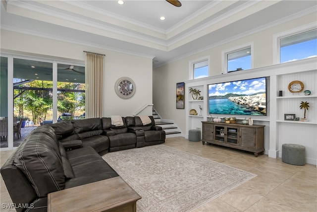 tiled living room with crown molding, a towering ceiling, and plenty of natural light