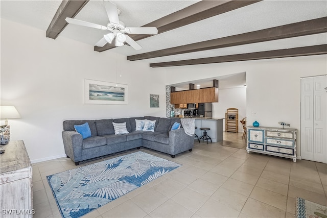 living room featuring light tile patterned flooring, ceiling fan, a textured ceiling, and lofted ceiling with beams