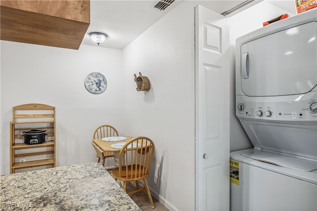 laundry room with stacked washer and clothes dryer