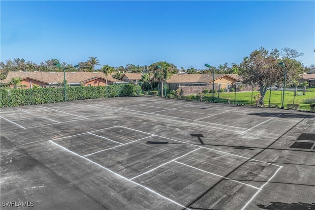 view of sport court featuring a yard